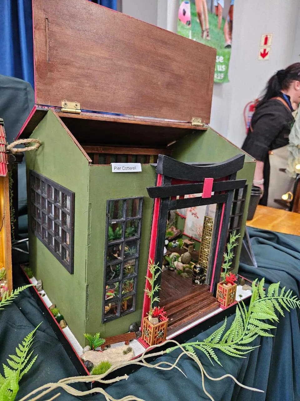 Miniature Japanese tea house with a torii gate and fern garden