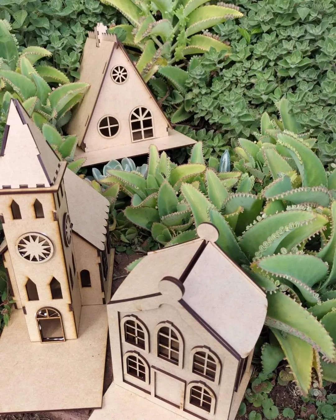 Laser-cut MDF church and houses among succulents